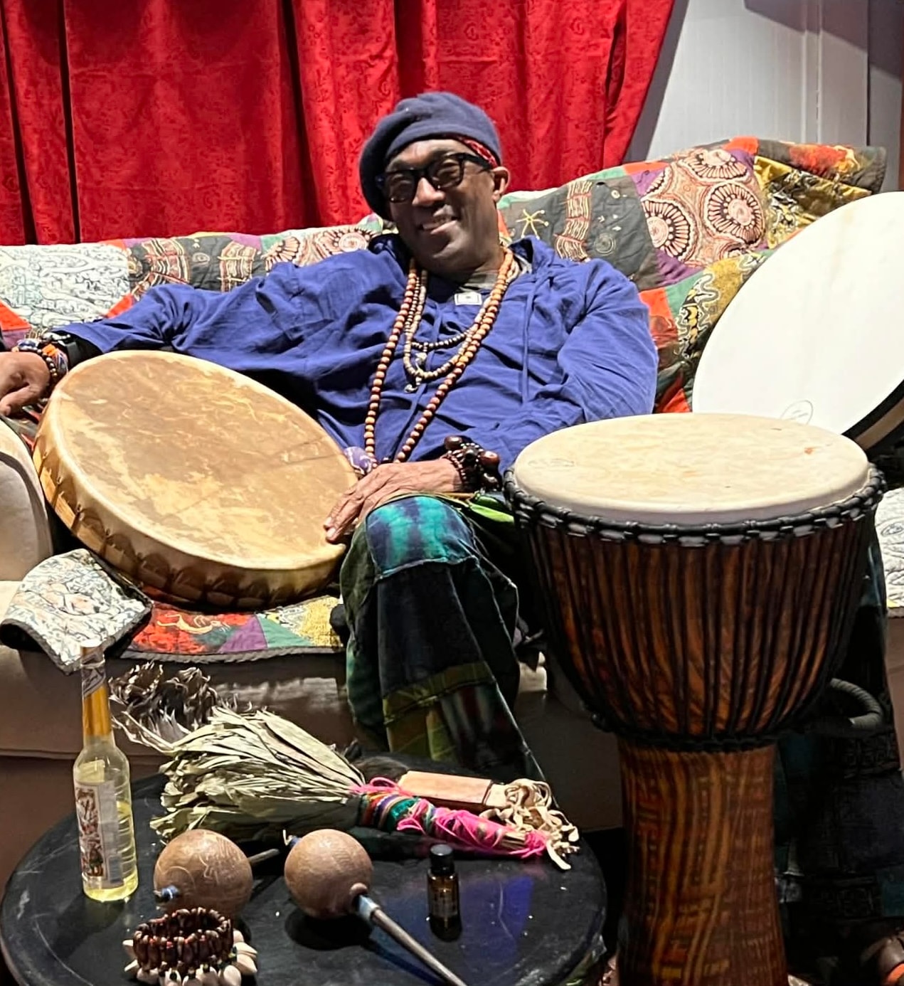 Joshua with drums and percussion instruments.